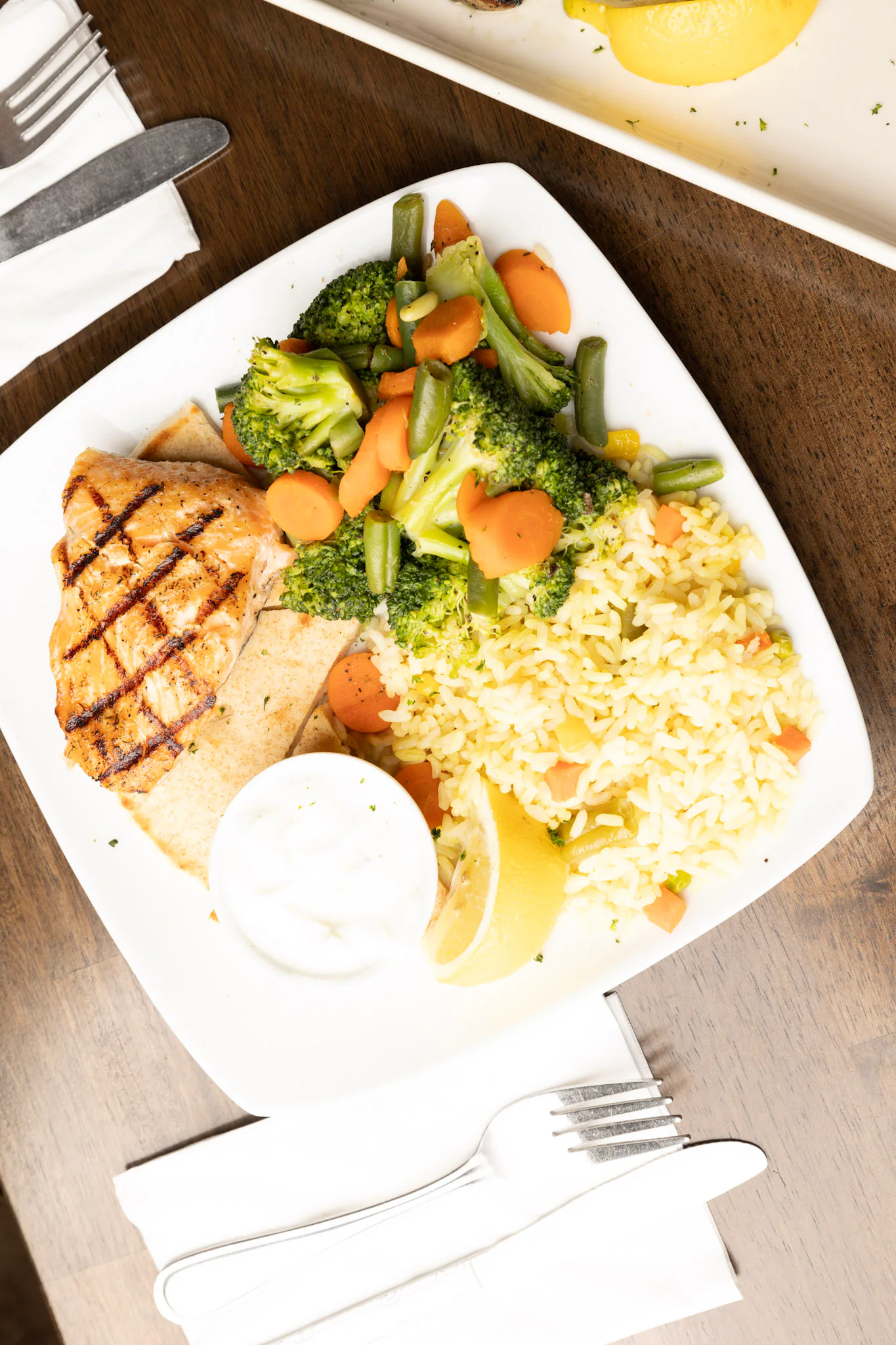 Grilled chicken, rice and vegetables served on a plate at George’s